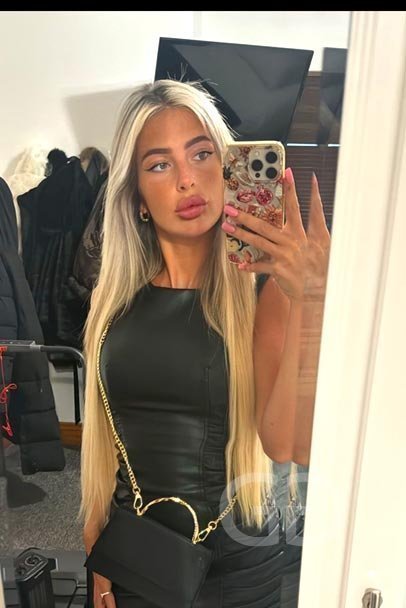 Alana mirror selfie in a black leather dress