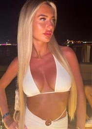 Alana thumbnail in a white bikini top at night
